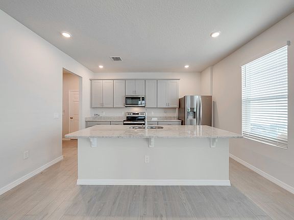 Kitchen with spacious island and stainless steel appliances