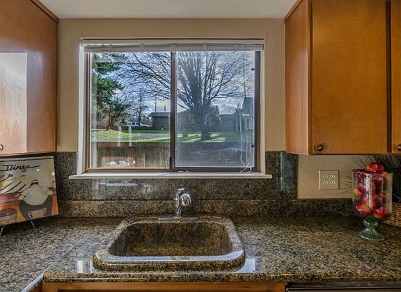 Kitchen sink is made out of the same granite as the counters.