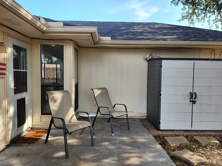Private back patio with garden shed.