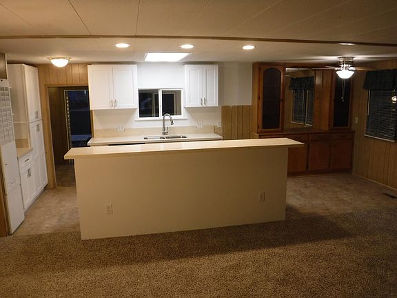 View of kitchen, living room and dining room from front door