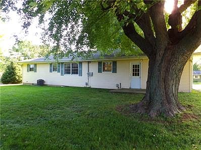 View of the back of the house. Mature trees & lots of shade.