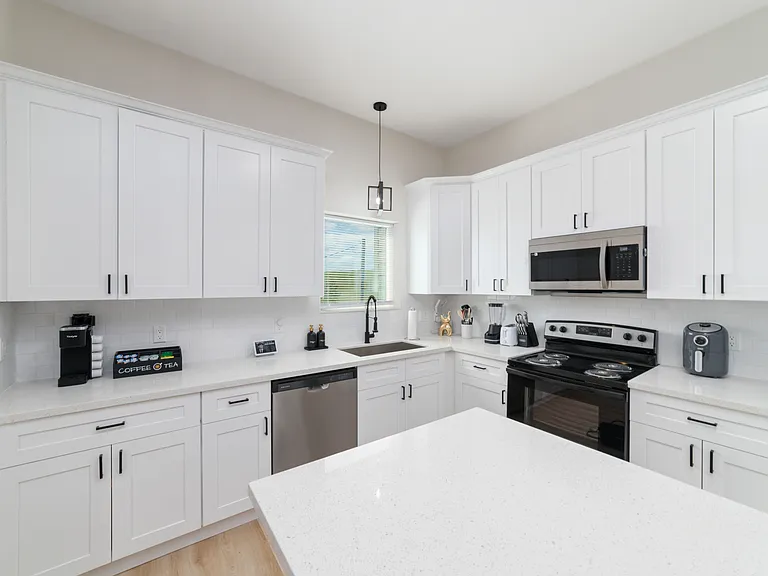 Kitchen area from bar stool view, Air fryer, complimentary dish soap and hand soap.