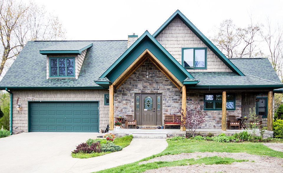 Best of all worlds!  You'll love the riverfront view from this fabulous home located on a very peaceful, private lot offering a park-like setting.  The home faces the river and is just a moment away from Sanford Lake.  Built in 2002, the quality and care shows throughout the home which has log-style interior which is unique and warm with knotty pine and beautiful hardwood floors, a fully finished walk-out lower level to the water and yard, an upper loft which overlooks the great room with gas-log fireplace and features a 2nd bedroom, office and full bath.  The main floor features the master suite and laundry room, a great kitchen with stainless appliances and island, formal dining room and eating area plus the Great Room.  The lower level is complete with bedroom, family room, bath, kitchenette/bar area, office and custom workshop for all your hobbies.  The lush yard has professional landscaping, perennials, sprinkler system and more!  The 30x50 outbuilding is sharp!  Call today!