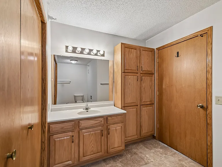 Elevate your living experience at Mill Pond Apartments with this spacious bathroom featuring elegant cabinets and ample storage. Enjoy a perfect blend of comfort and style. Explore your new home today!