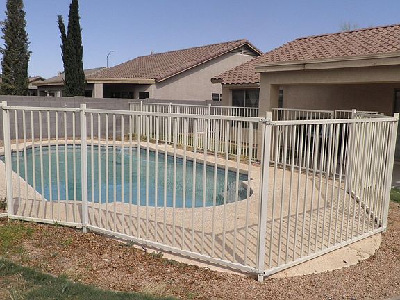 Covered patio at right rear of pool fence.