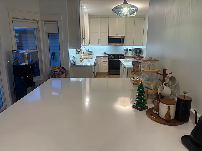 Kitchen island with kitchen in background.