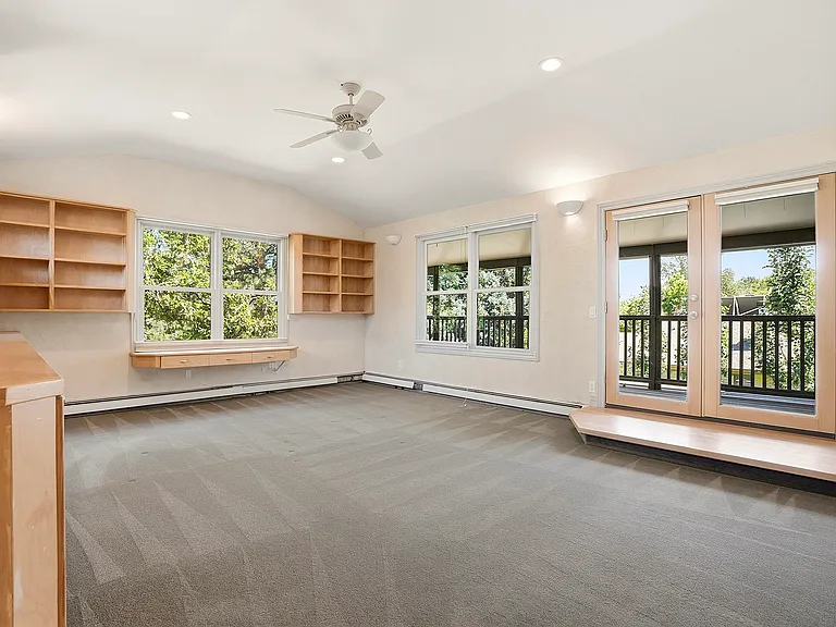More than an office, this inspiring upper-level retreat features built-in storage, abundant natural light, and a private balcony_an ideal space for work, creativity, reflection, or simply taking a peaceful break.