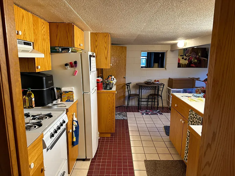 kitchen with stove and fridge clean with ceramic tile