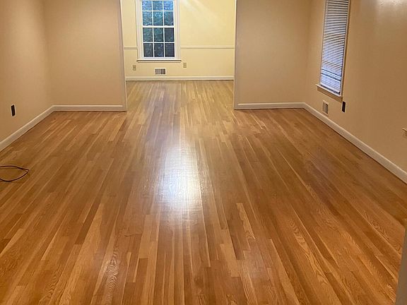 Large living and dining area with refinished wooden floors