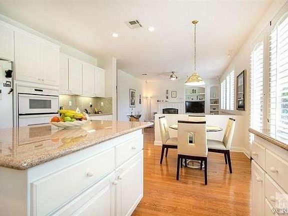 Beautiful Gourmet island kitchen with view into the family room in the background. french doors lead