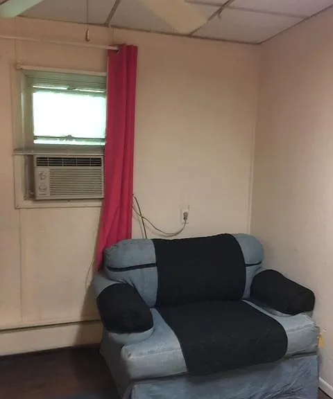 THIS IS THE BIG EASY CHAIR IN THE BEDROOM WHERE ONE BIG PERSON OR TWO SMALL FRIENDLY PEOPLE CAN RELAX.