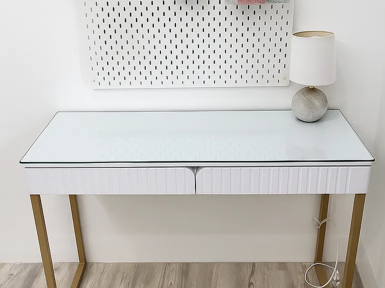 Modern wood desk with a clear glass top and handy wall organizer.