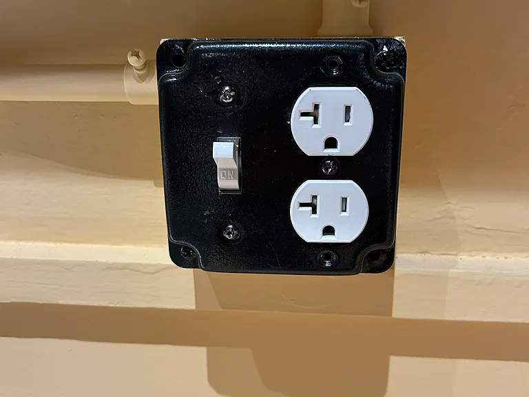 Example outlet: in the kitchen, by the sink, with modern light switch.