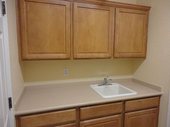 Laundry room with cabinets and sink