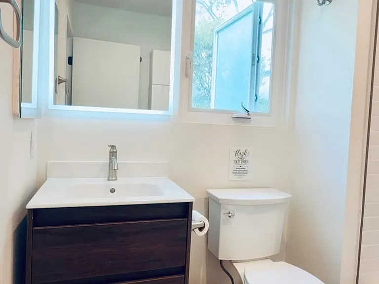 Clean, modern bathroom with bright vanity lighting and fresh, updated finishes.