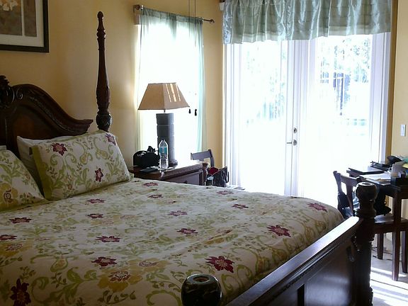 Master bed with french doors open to pool