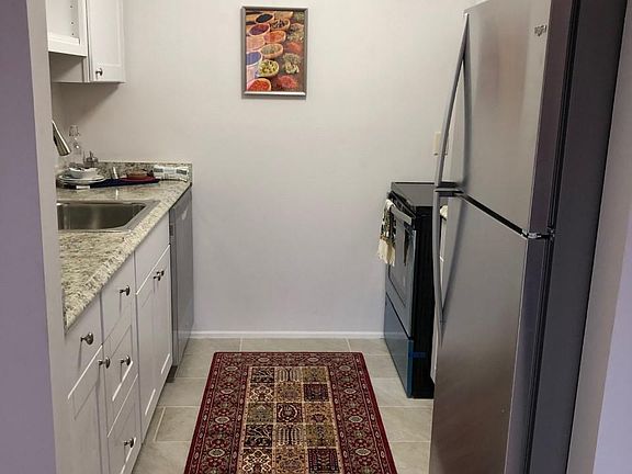Kitchen with new appliances and cabinet