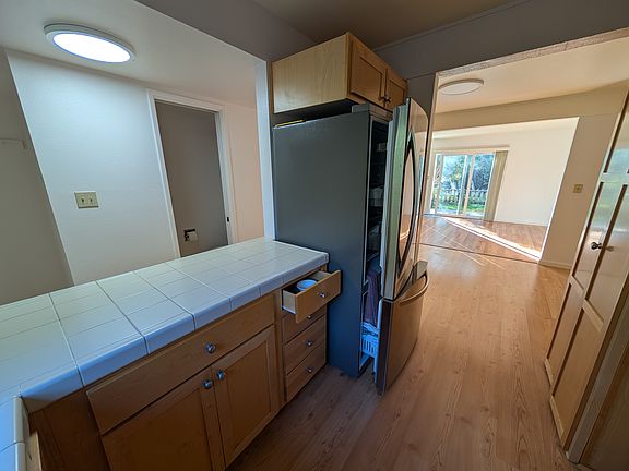 View from kitchen. Half bathroom at left, dining room, living room, and garden.