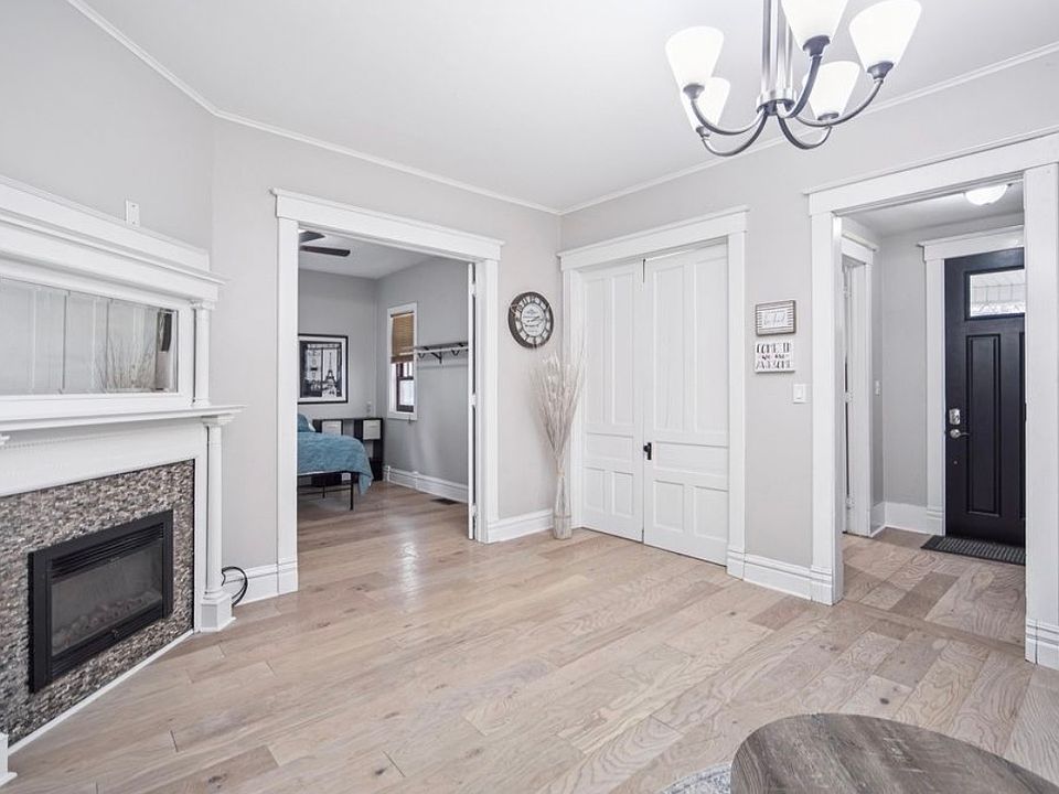 living area with view of entry and two bedrooms
