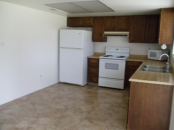 Tiled kitchen with refrigerator