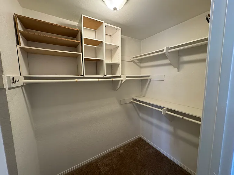 Primary bedroom walk-in closet
