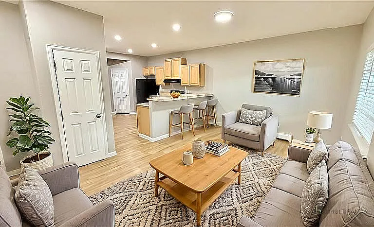 Inviting open-plan living space with modern kitchen, cozy seating area, and elegant decor, perfect for relaxation and entertaining.
