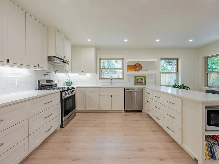Functional kitchen with ample cabinetry, 5 burner gas range, generous counter space, and thoughtful layout for everyday convenience.