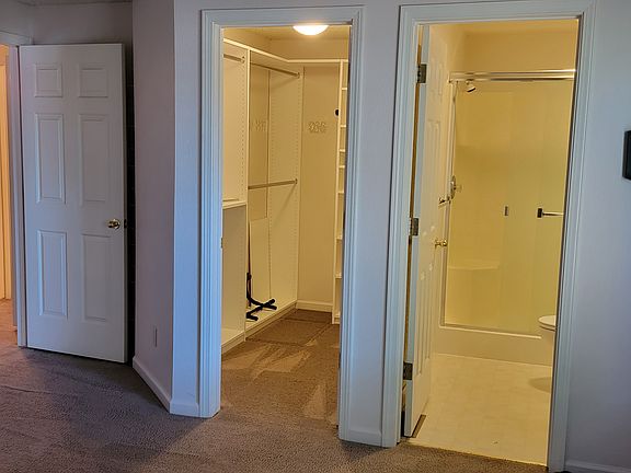 View of bathroom, walk in closet and hallway from inside master bedroom