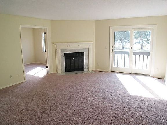 Living room has fireplace and access to deck.
