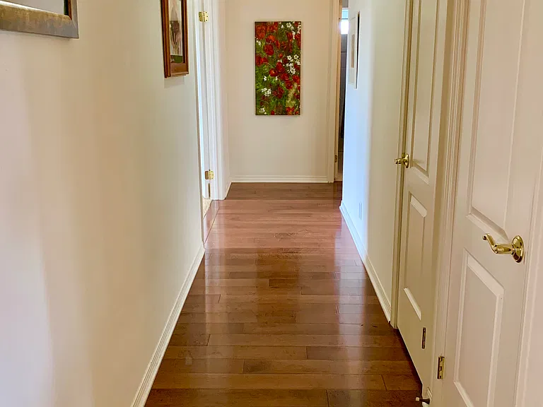 Hallway with skylight to the bedrooms, house, bathroom, and laundry room with Maple hardwood floors.
