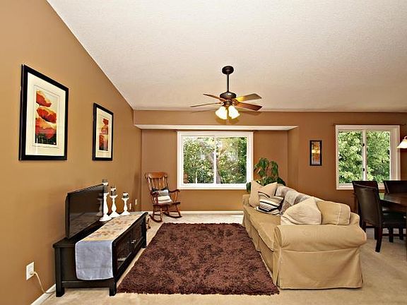 Large living room with vaulted ceilings and gorgeous view of the private backyard!