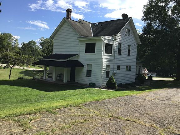 View of back of house. This shows the covered porch entrance and large yard for the downstairs apartment (Apartment B).