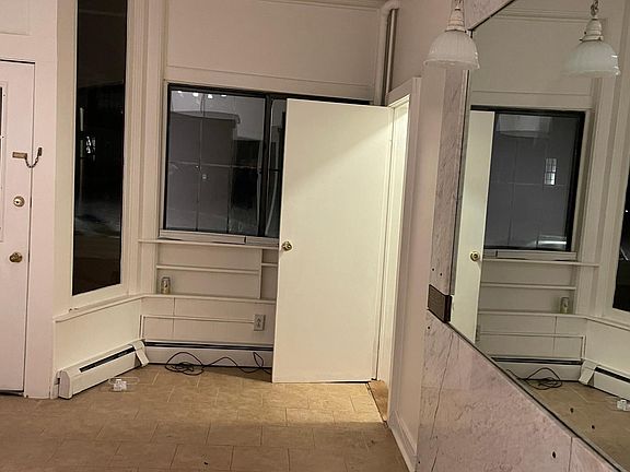 Living room with ceramic tile, marble wall, mirror