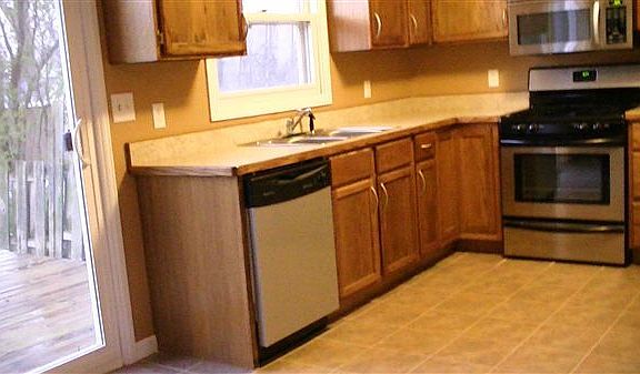 Another angle of kitchen and walk out deck and fenced in bac