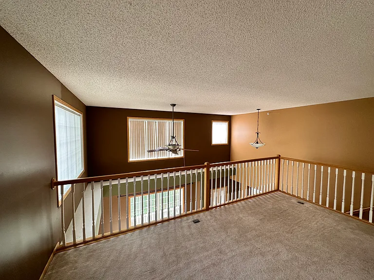 Another view of the oversized loft surrounded by windows and natural lights over looking the living room.