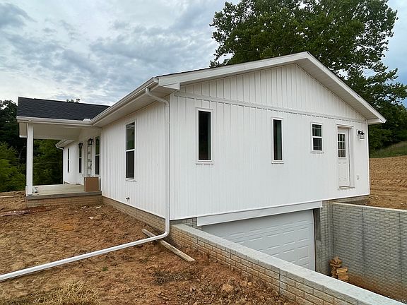 2-car garage lower entry; unfinished basement with lots of storage and staircase to living space above.