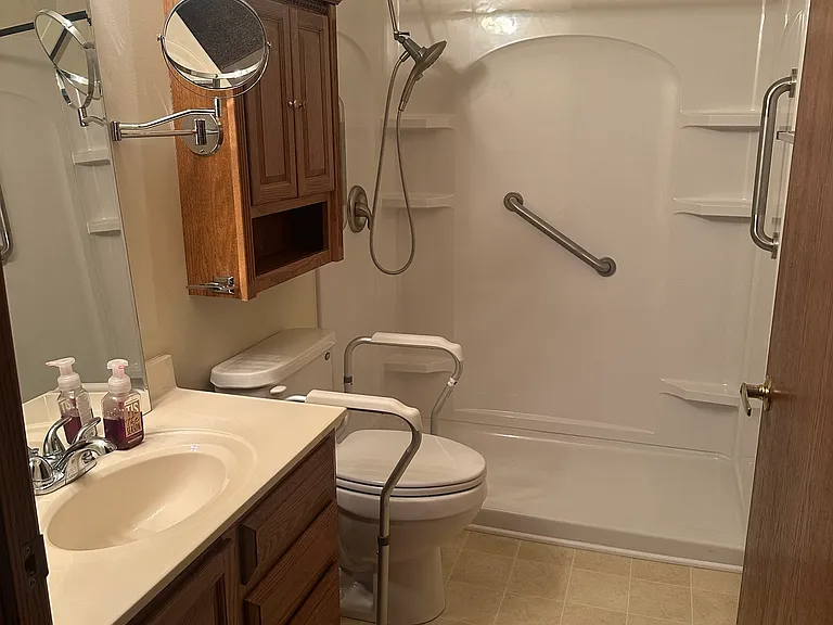 Bathroom has a new walk-in shower with grab handles, shelves, and a magnetic extendable shower head. Room to add a shower seat if needed.