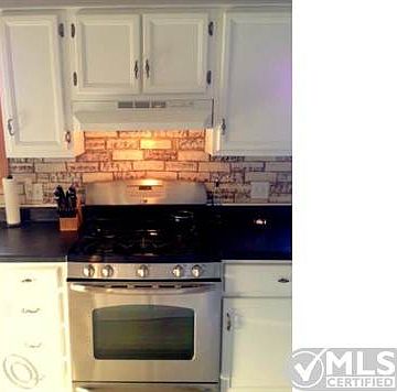 Kitchen cabinets and backsplash.