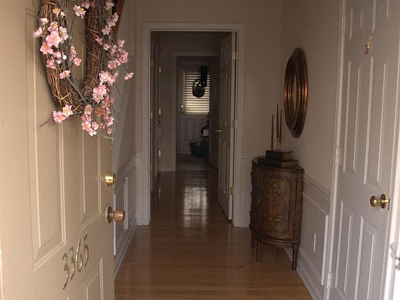 Entryway to bedroom1, 1 half bath, laundry, coat closet, backyard and garage