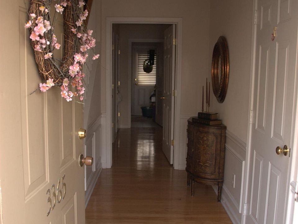 Entryway to bedroom1, 1 half bath, laundry, coat closet, backyard and garage