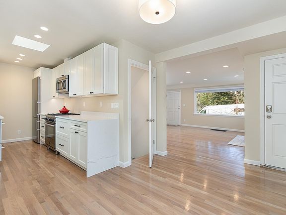 Kitchen, dining room - looking to living room. Waterfall countertop.