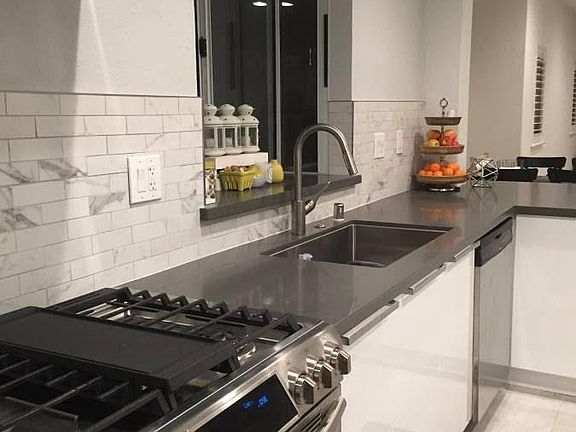 Remodeled kitchen with stainless steel appliances.