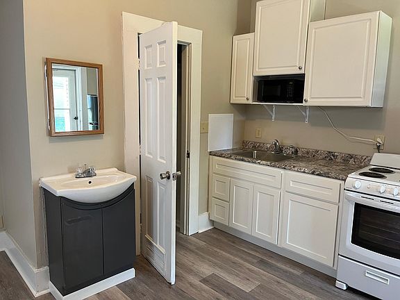 Kitchen wall, door to bathroom, sink