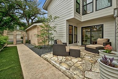 Walkway into private yard with 2 separate outdoor patio & seating areas for outdoor living.