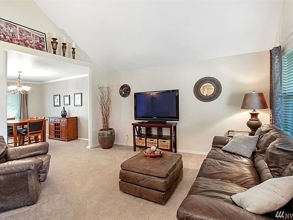 And more vaulted ceilings!  Home lives much larger than its listed square footage!  This welcoming formal living room is located right off of the entryway.  