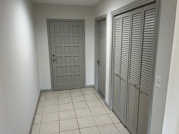 Foyer with garage entry door to the right of front door and large coat closet