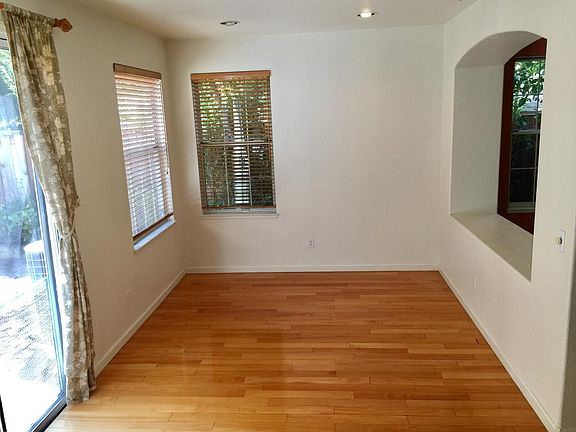 Dining room with a lot of natural light, facing a private backyard