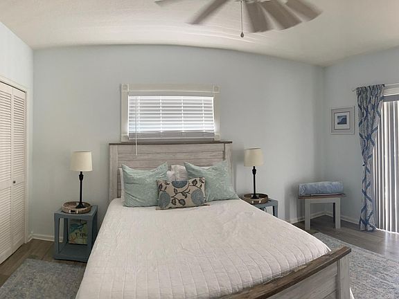 Queen sized guest room, with attached bathroom, and door to patio on 2nd floor.