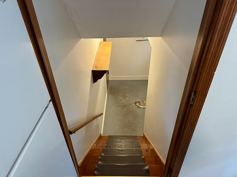 Stairs off of kitchen down to Washer & Dryer/Garage