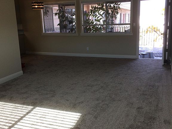 Looking toward front door from the living room window. This "dining room" along the windows can handle a 12 seater dining room table set.